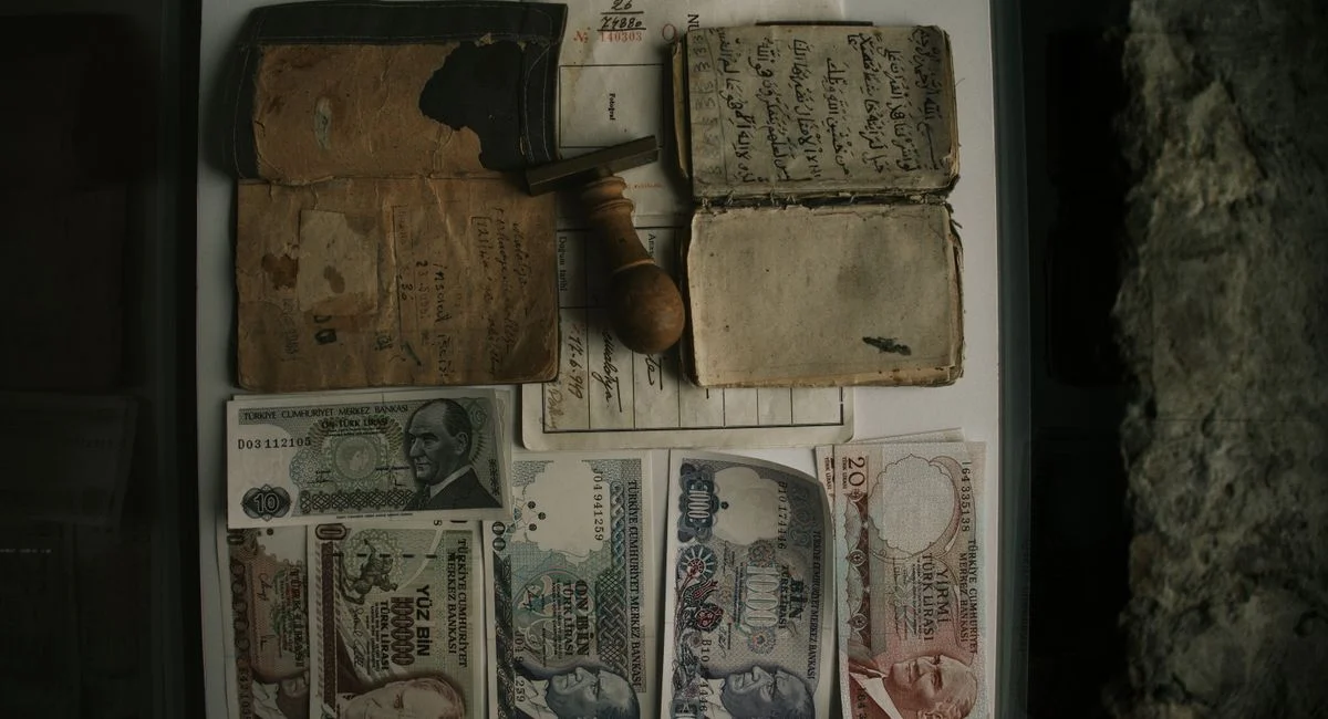 Top view of vintage banknotes, old documents, and a stamp, preserving history.